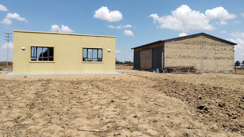 The Firstfield base at Olonini: the yellow office building with the grain store behind it